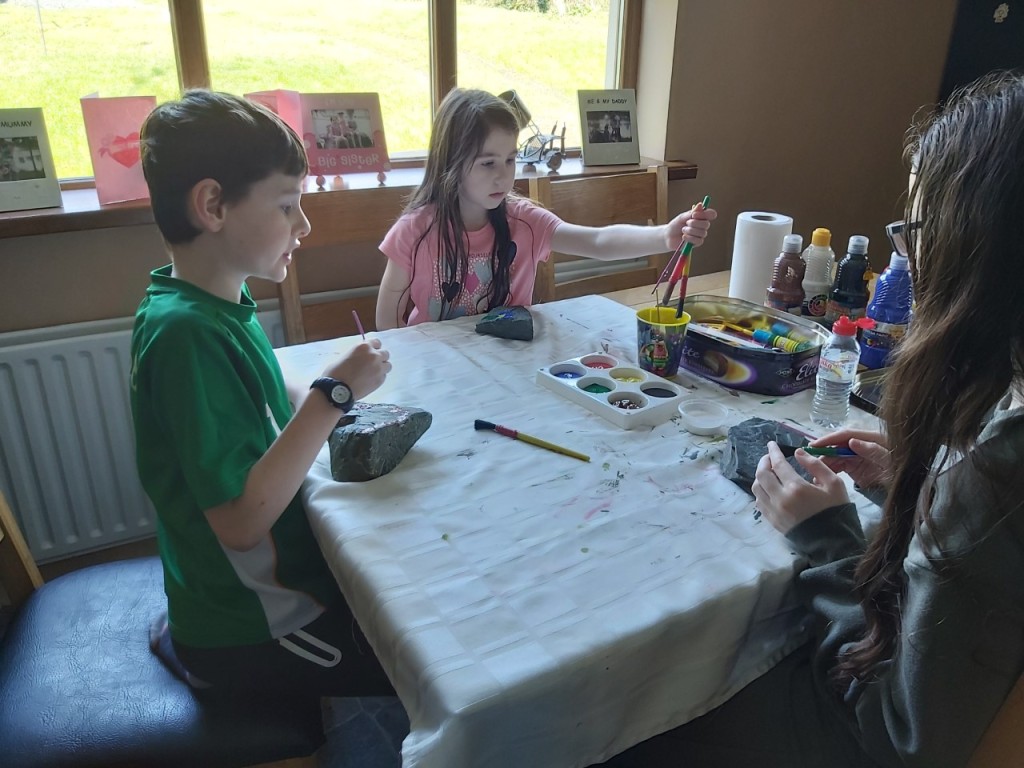 The Fay family taking a break from school work to do some rock painting.