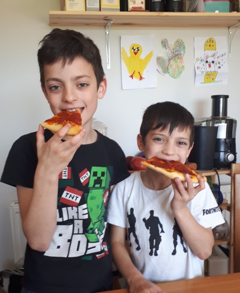 Adam and David eating their homemade pizza.